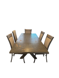 Dining table with six upholstered chairs on a patterned rug