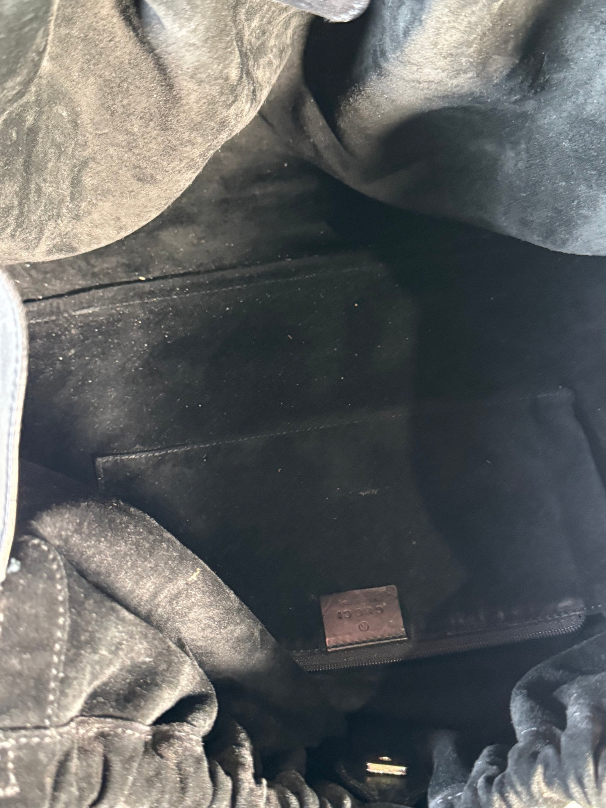 Interior detail showing brown leather label patch against black fabric lining