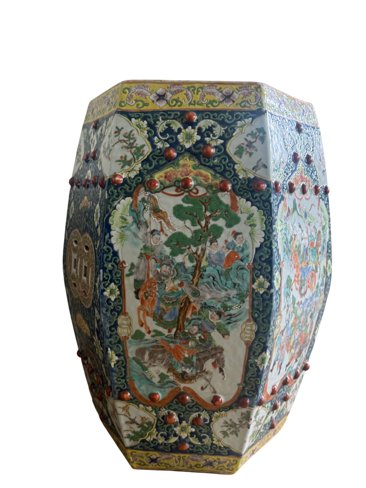 Hexagonal porcelain garden stool with famille rose decoration, dark blue borders and red ceramic spheres, full side view