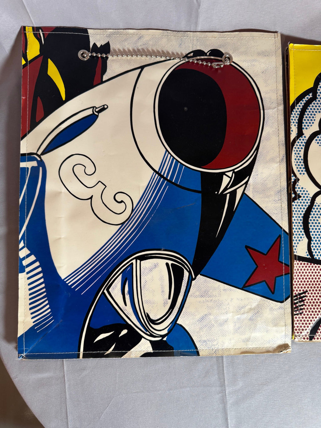 Close view of comic-panel artwork on a bag