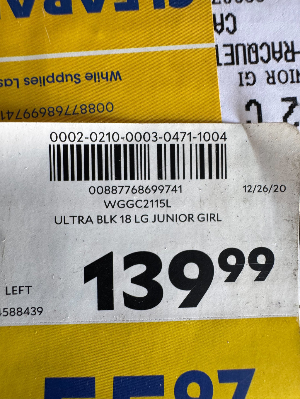 Price tag and product label reading 'ULTRA BLK 18 LG JUNIOR GIRL' with barcode, dated 12/26/20, priced at $139.99, left-hand set