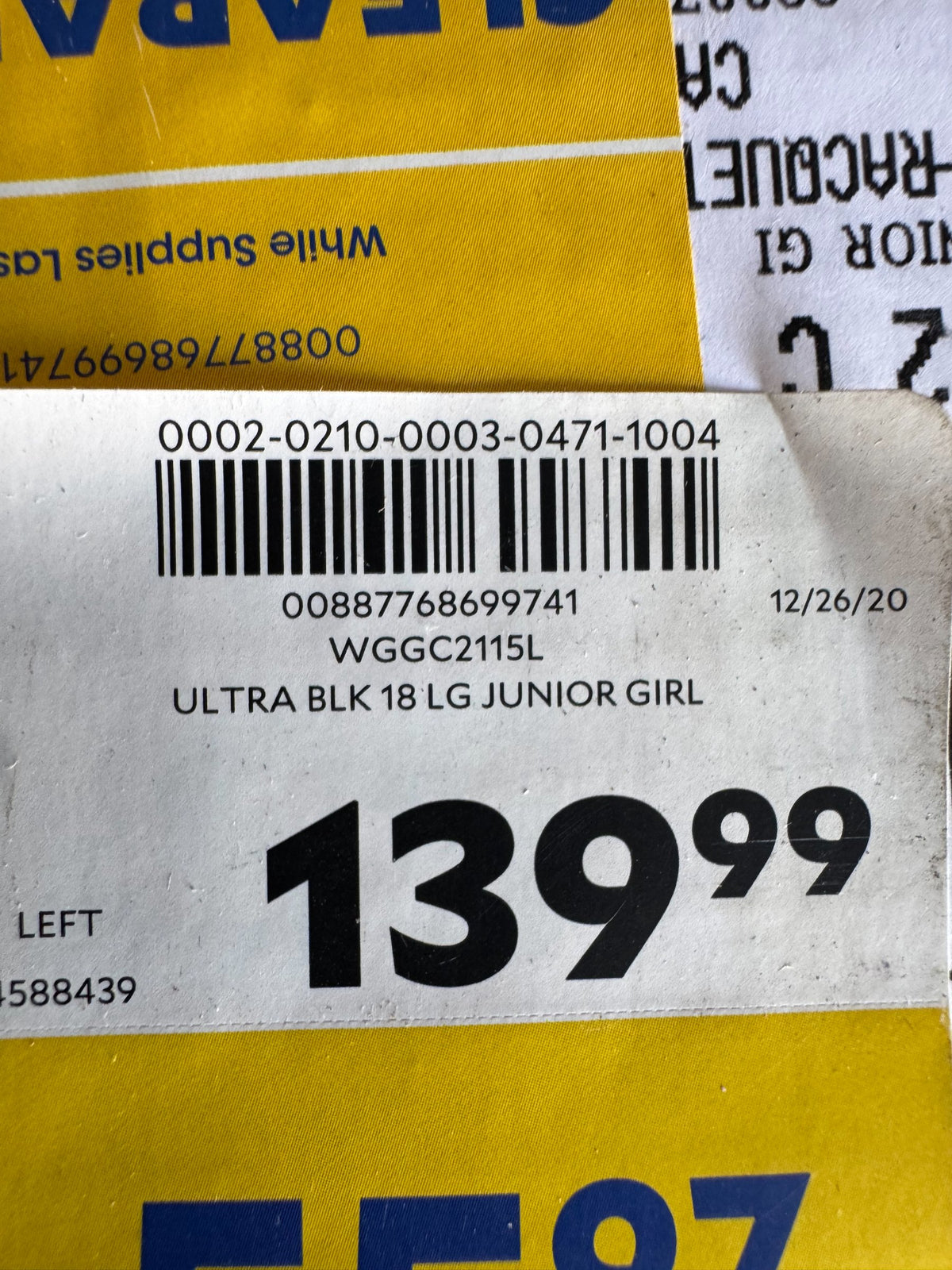 Price tag and product label reading 'ULTRA BLK 18 LG JUNIOR GIRL' with barcode, dated 12/26/20, priced at $139.99, left-hand set