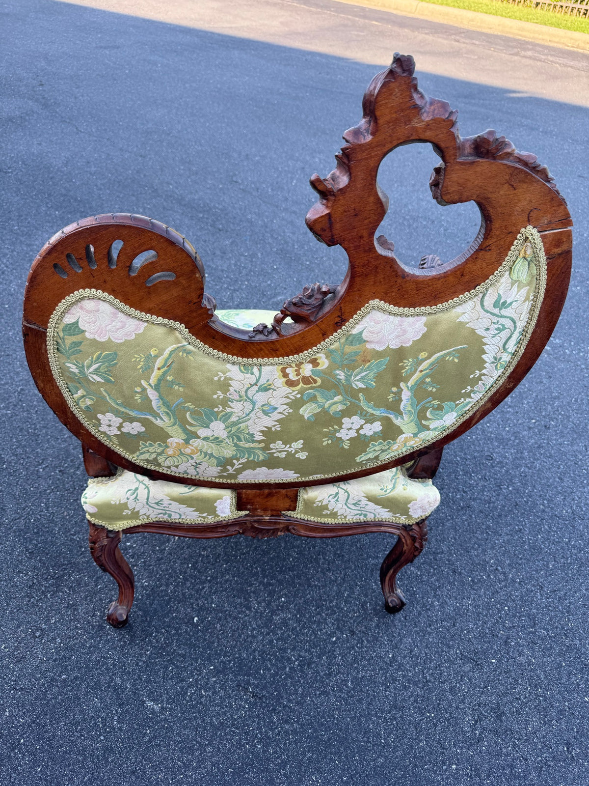 The chair from behind, showing the back cut from a single shaped plank and the pierced crest