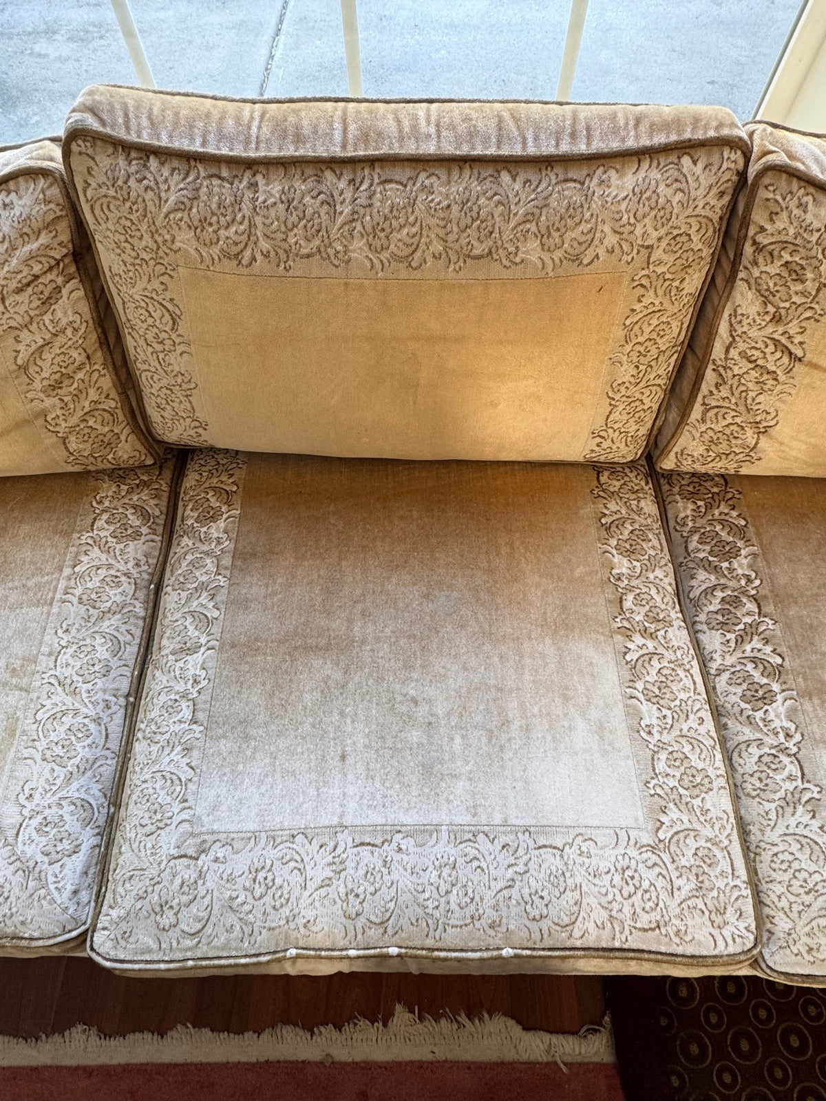 Seat cushions showing the floral border and worn, soiled centre panels