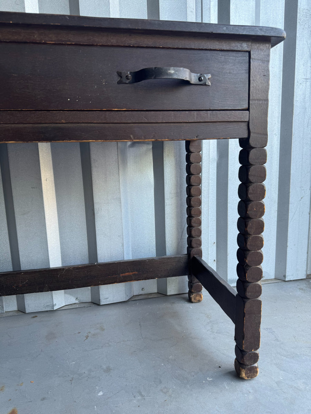 Open drawer interior revealing lighter wood lining, metal handles visible from inside