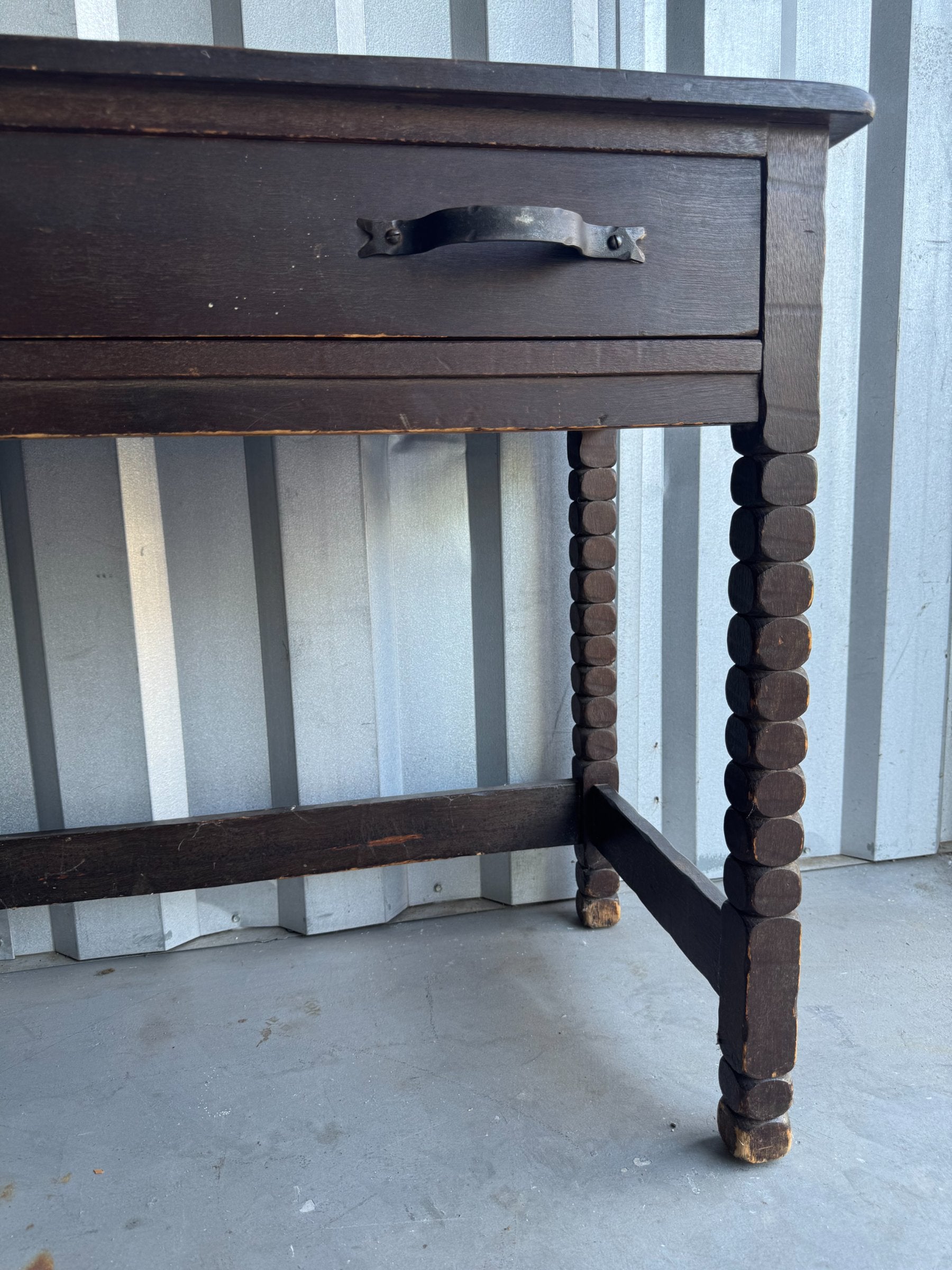 Open drawer interior revealing lighter wood lining, metal handles visible from inside