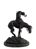 Bronze sculpture of Native American on rearing horse, mounted on green patina base, viewed from front angle