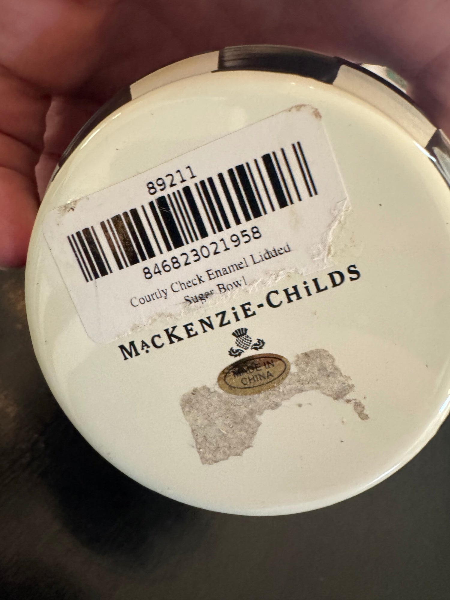 Barcode label and text reading 'Courtly Check Enamel Lidded Sugar Bowl' and 'MACKENZIE-CHILDS' with 'MADE IN CHINA' mark on base
