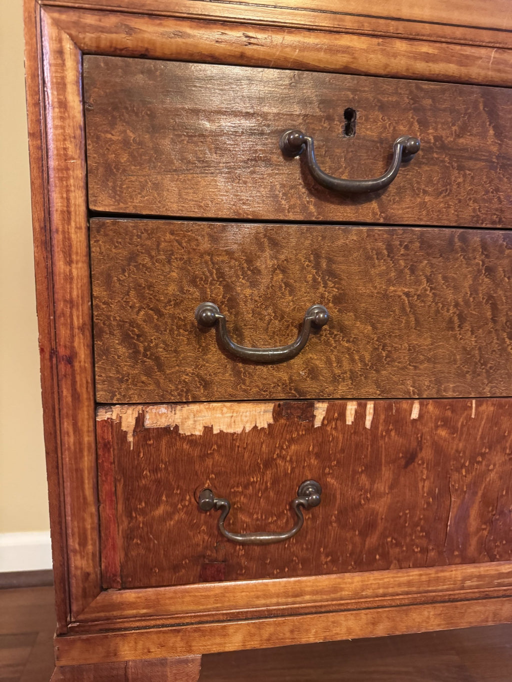 Bottom drawer with veneer loss along the top edge