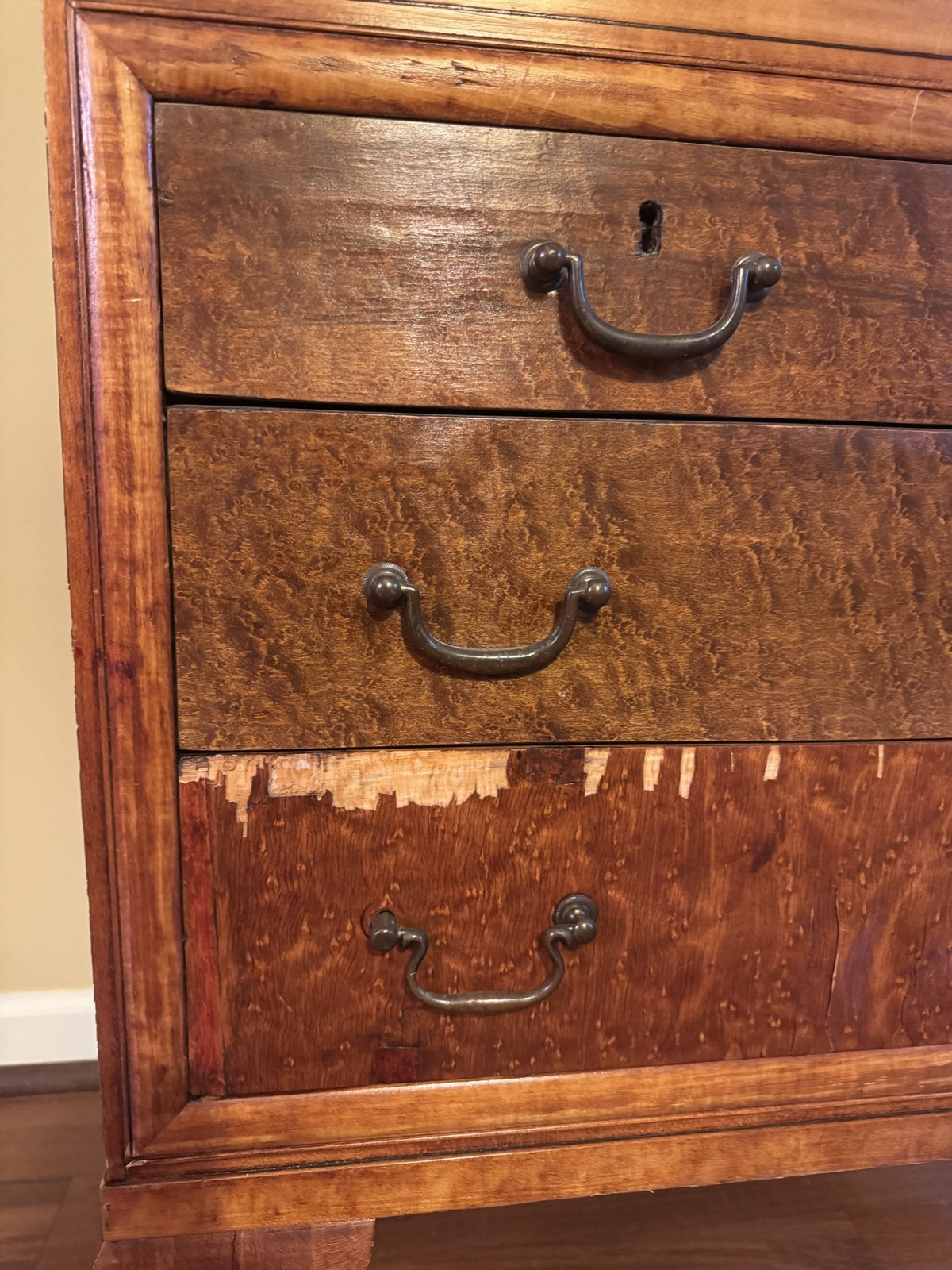 Bottom drawer with veneer loss along the top edge