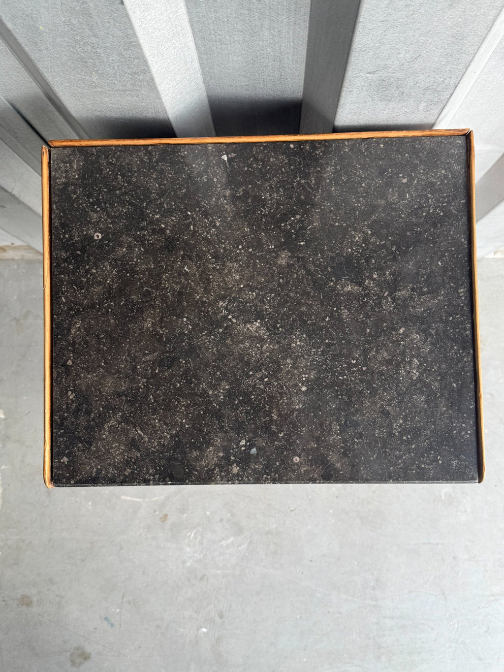 Top surface with dark slate or stone inlay and wood border, viewed from above