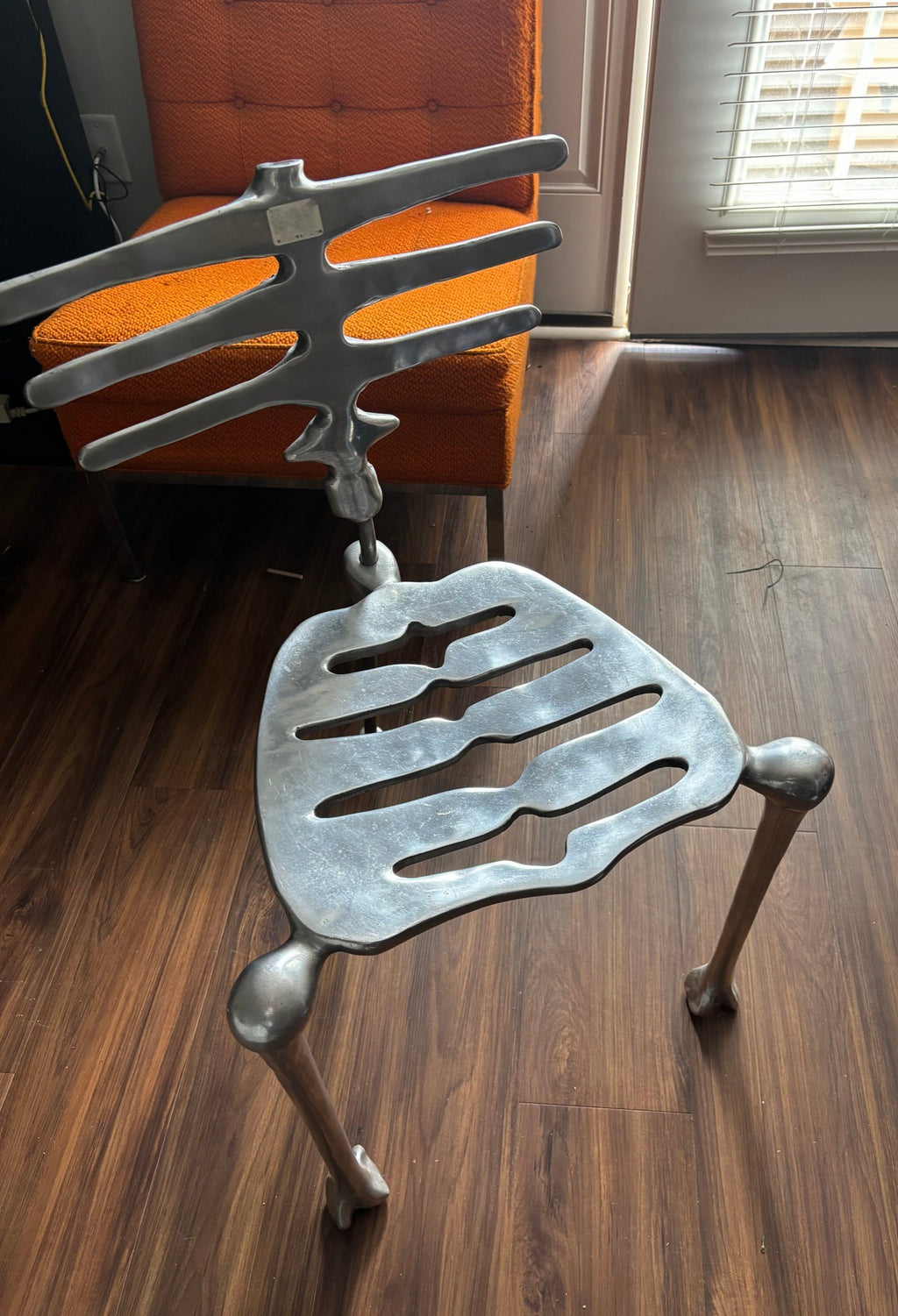 Skeleton chair indoors, three-quarter view