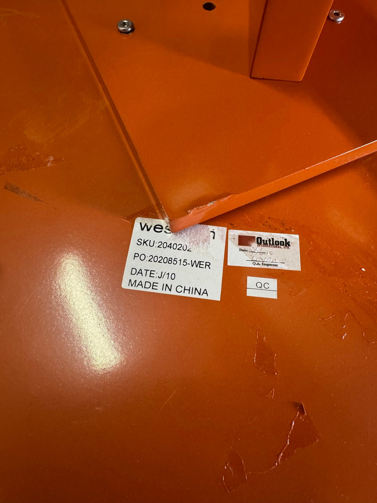 Partly torn label on the underside of the table