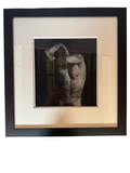 Framed black-and-white photograph of a torso with ink spatter, straight-on