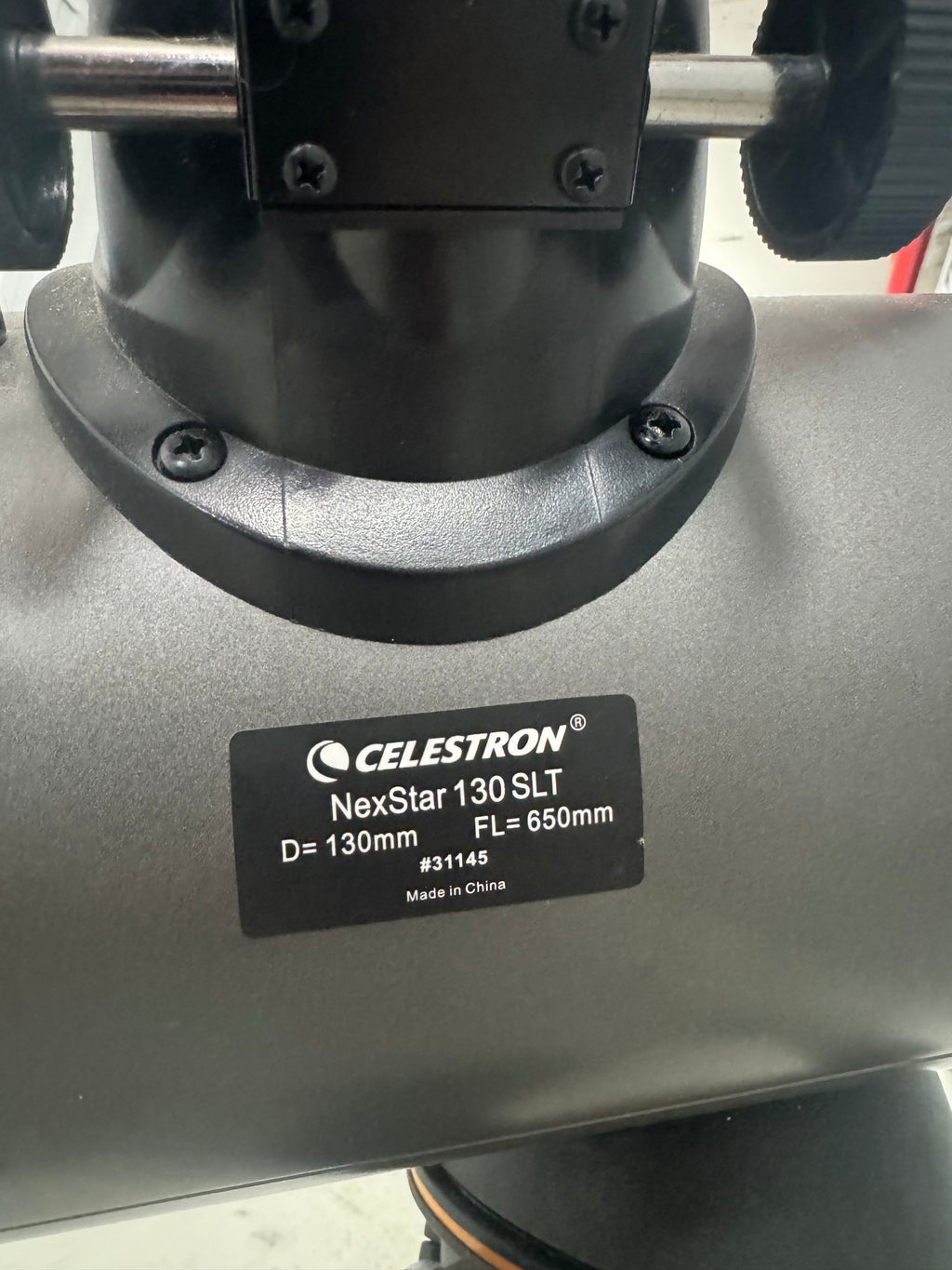 Close-up of telescope base label reading: Celestron NexStar 130 SLT, D=130mm, FL=650mm, #31145