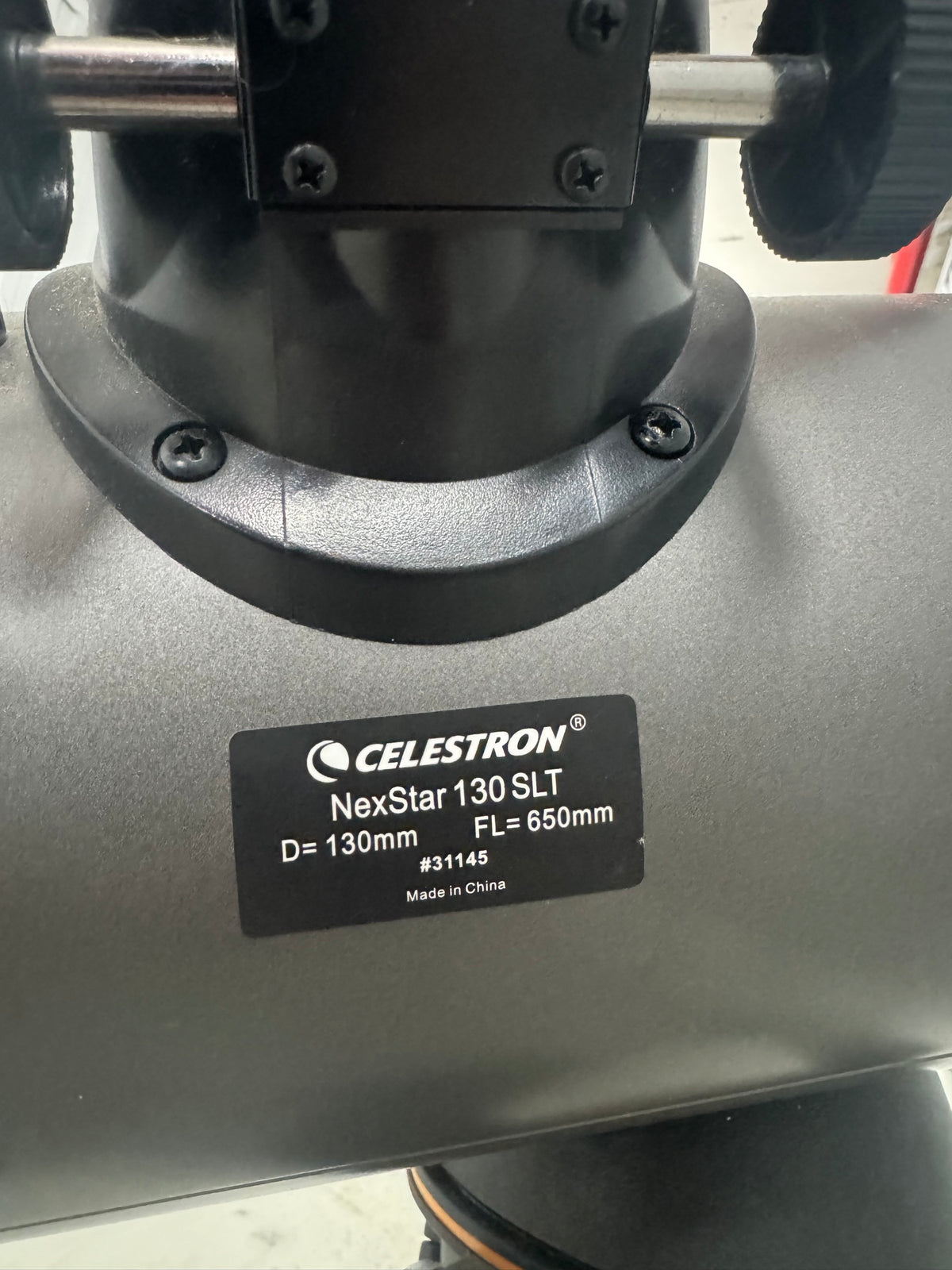 Close-up of telescope base label reading: Celestron NexStar 130 SLT, D=130mm, FL=650mm, #31145