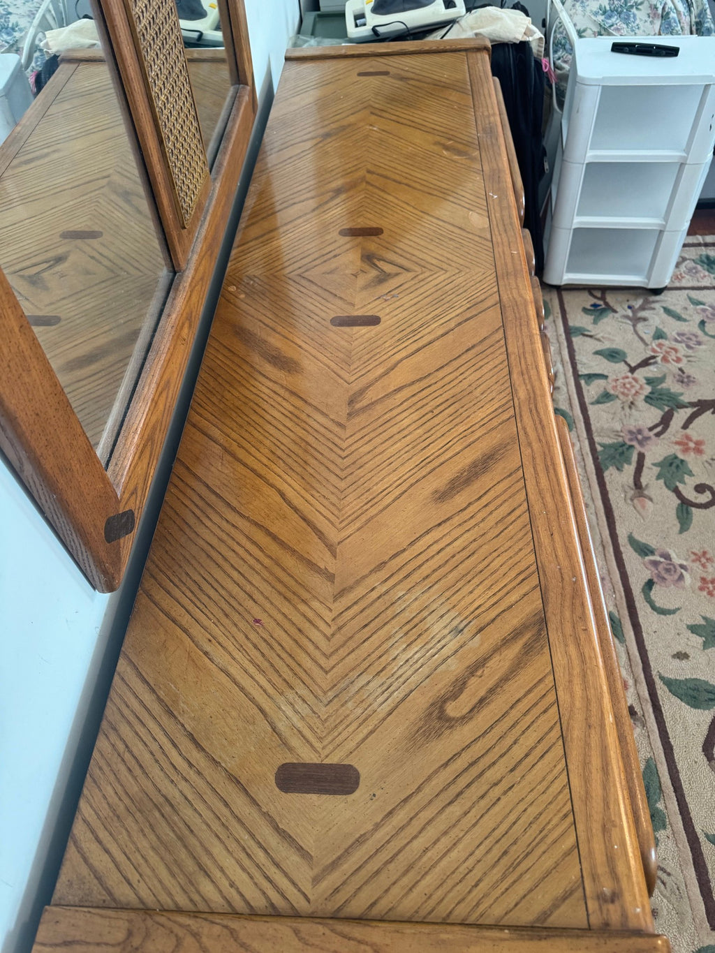 Chevron-pattern top of the dresser with a mirror reflected