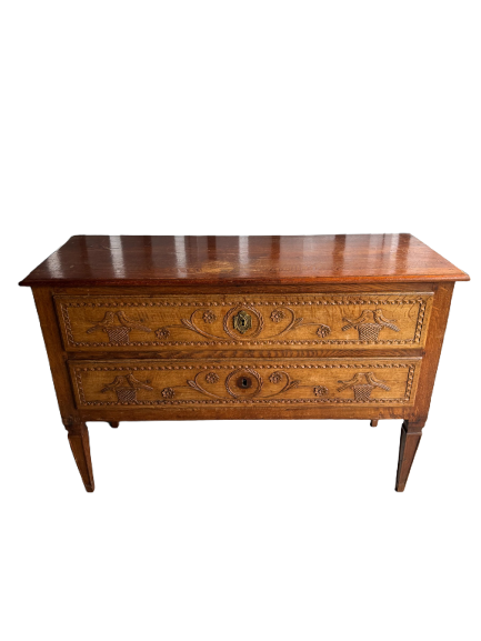 Full front view of antique oak commode with two carved drawers and tapered legs