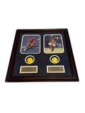 Framed display with photos of Serena and Venus Williams and two signed tennis balls in cutouts, resting on a bed