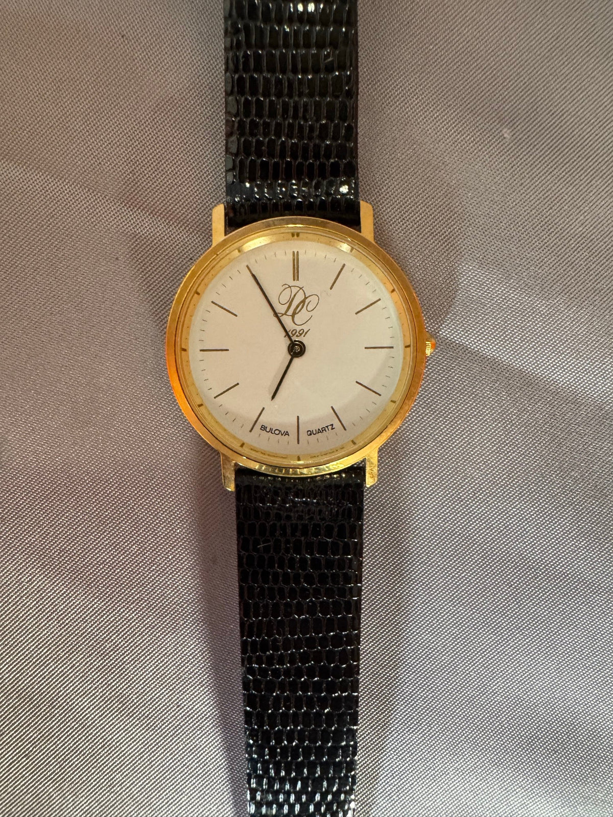 Bulova gold-tone watch, face up