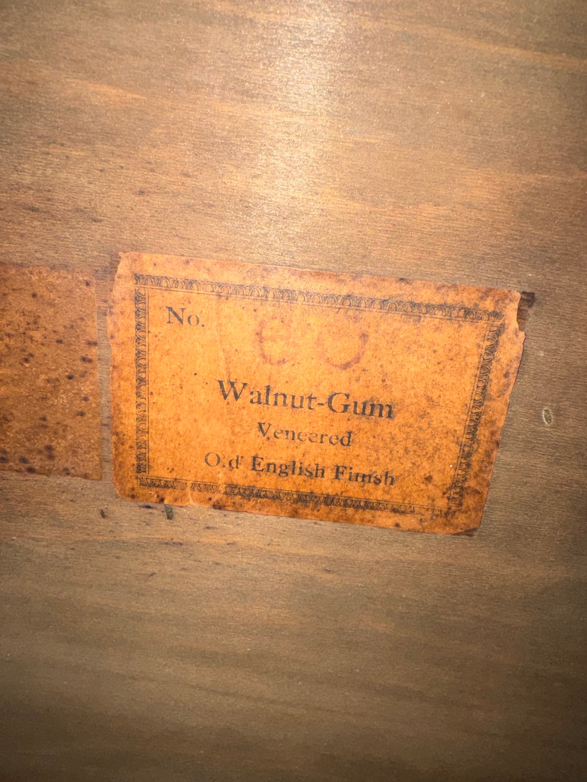 Maker's label on underside reading 'No. Walnut-Gum Veneered Old English Finish'