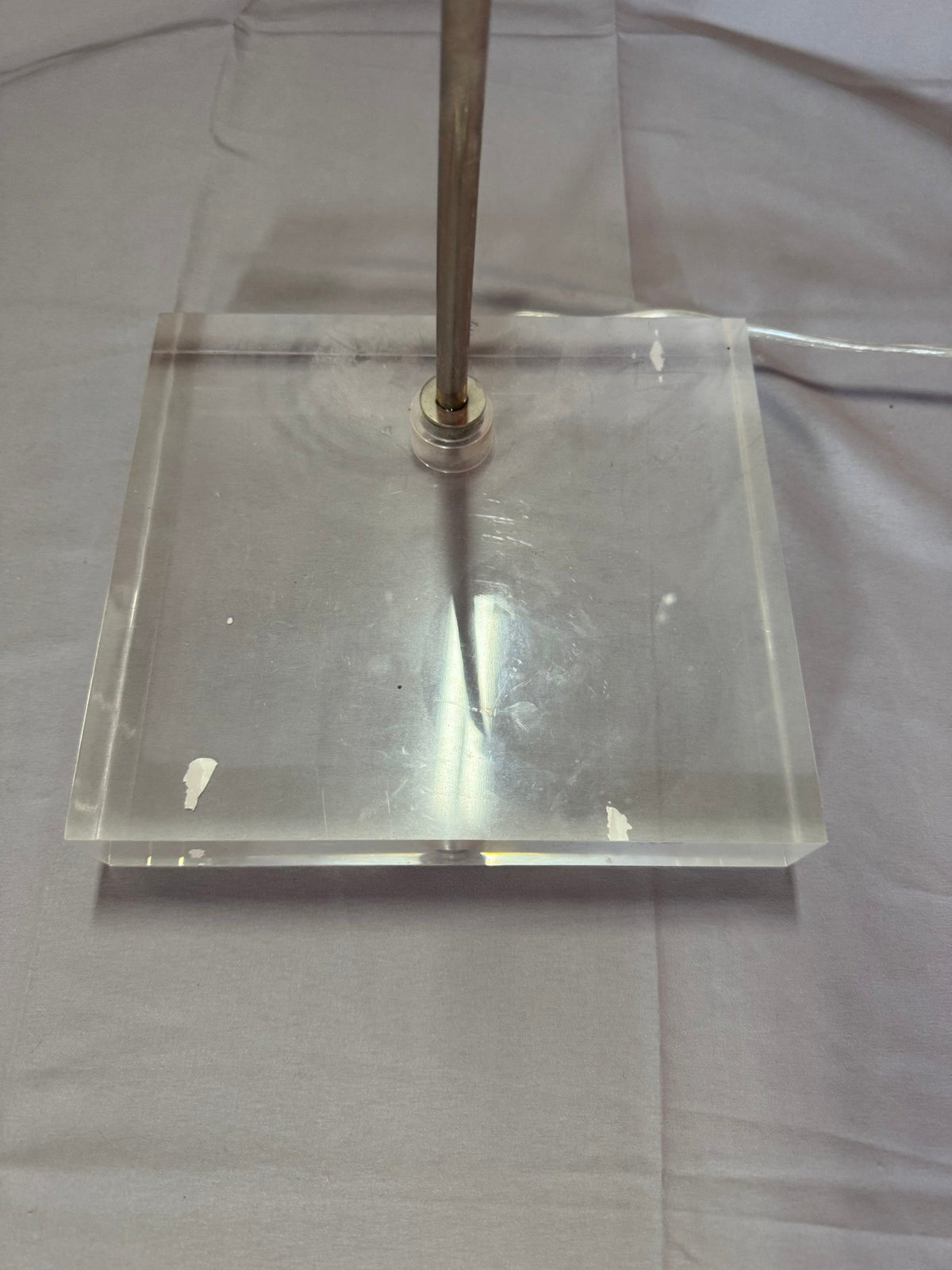 Close view of the lucite base showing scratches and marks