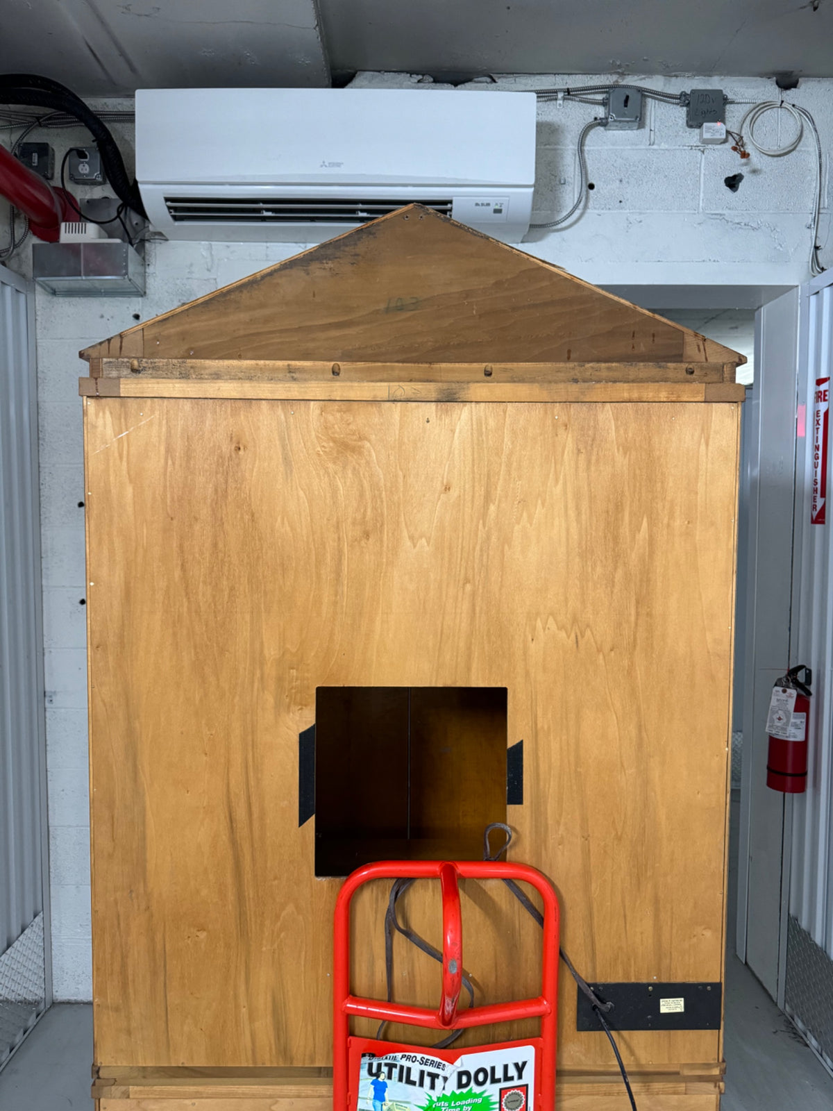Rear view showing plain plywood backing and AC unit mounted above