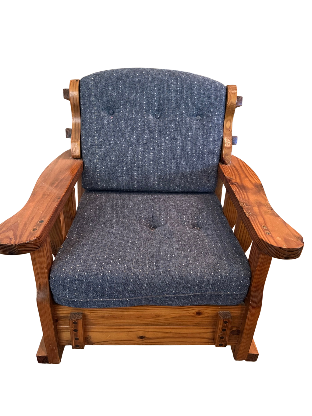 Rustic wood rocking chair with blue tufted cushions seen from the front