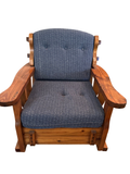 Rustic wood rocking chair with blue tufted cushions seen from the front