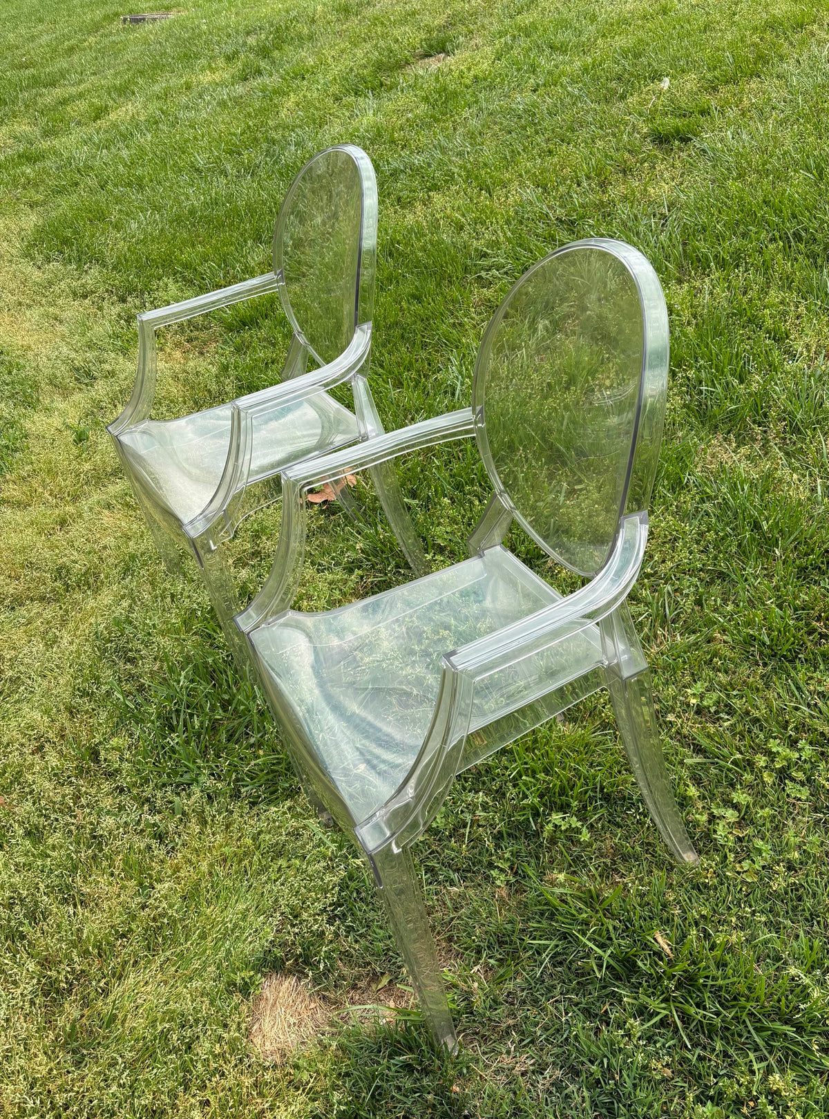 Two clear armchairs outdoors from another angle