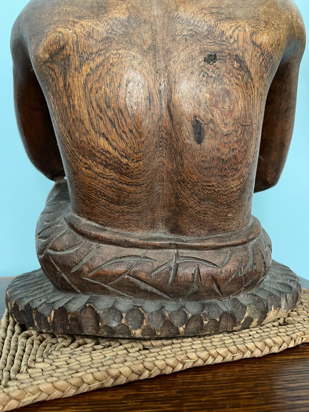 Front torso detail showing carved wooden chest and arms, wood grain and surface patina