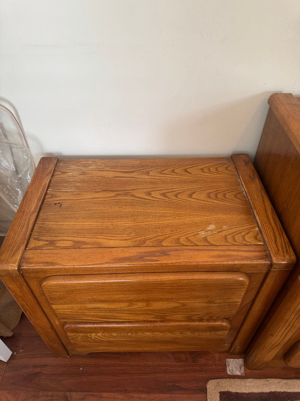 Oak nightstand from above showing the top and drawer fronts