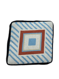 Vintage needlepoint pillow cover displayed flat, showing geometric square design in blue, cream, rust and black with diagonal striped border