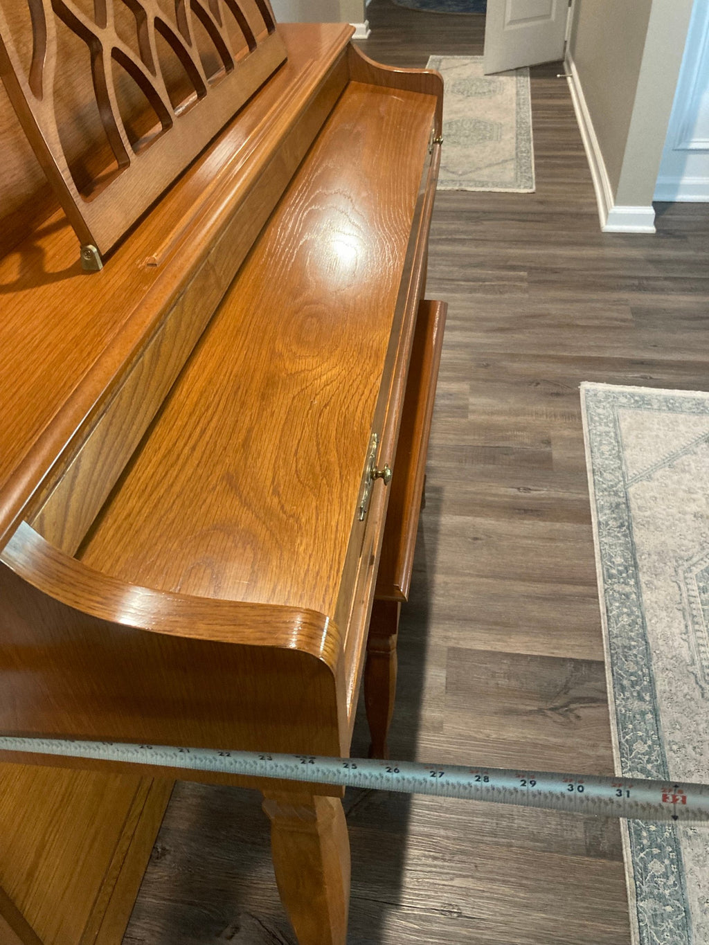 Baldwin 665 oak console piano keyboard lid and front leg with a tape measure across the depth