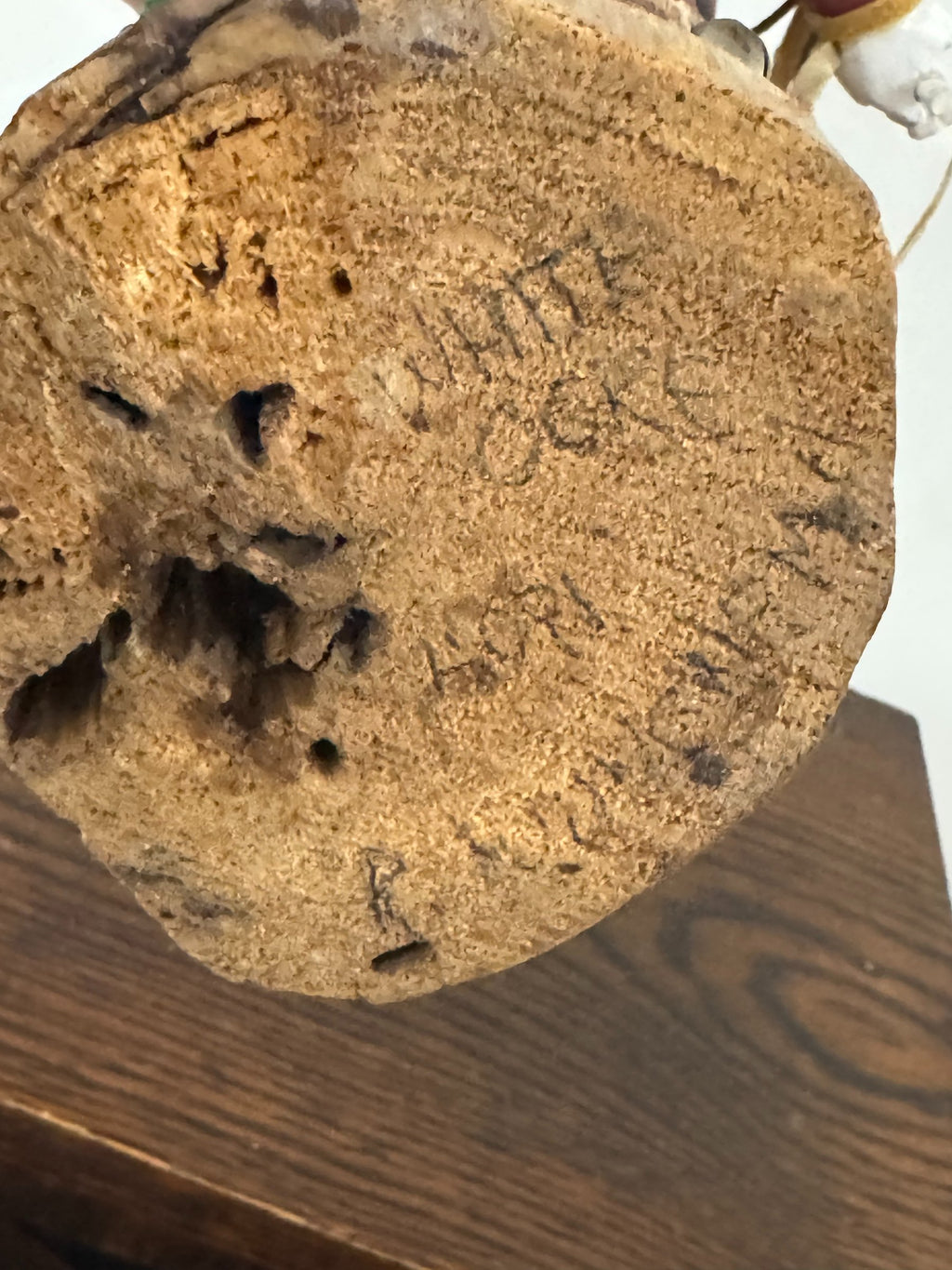 Close-up of circular wooden base showing natural wood grain and surface texture