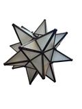 Moravian star candleholder with frosted glass triangular panels and dark metal frame, three-dimensional geometric form