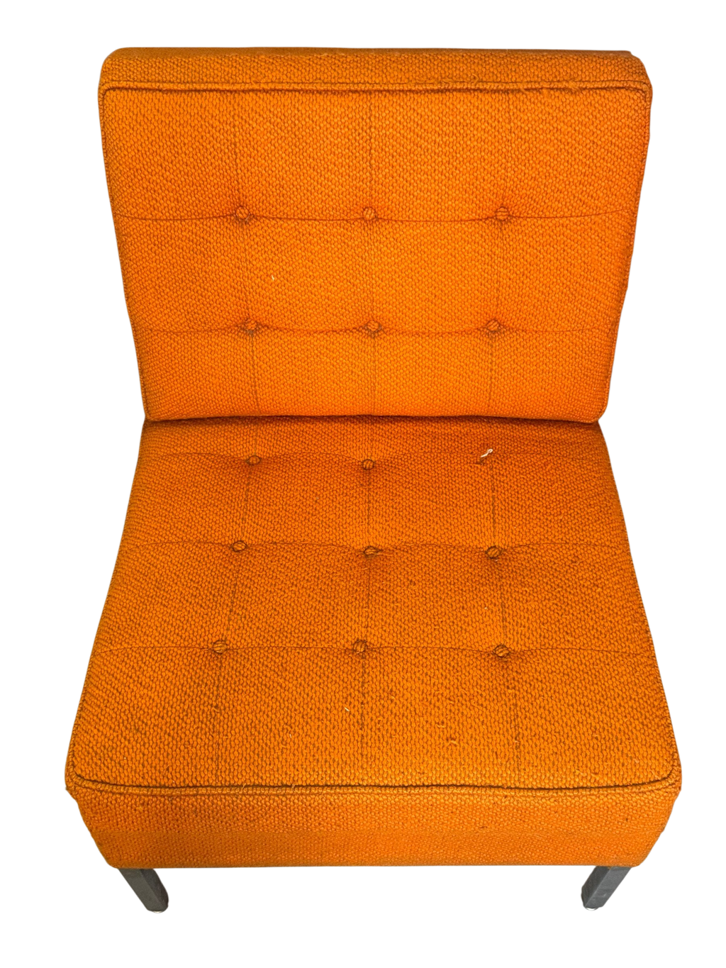 Orange slipper chair seen from above showing seat and tufted back