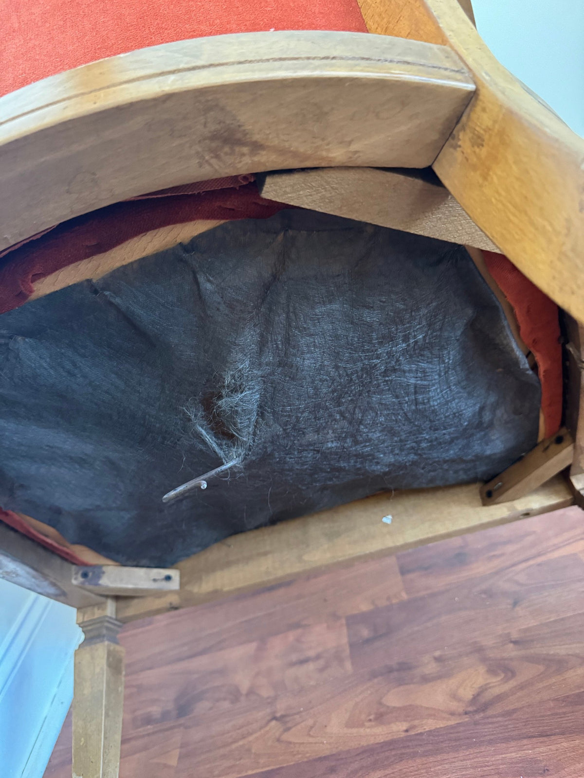 Underside of the seat showing torn webbing