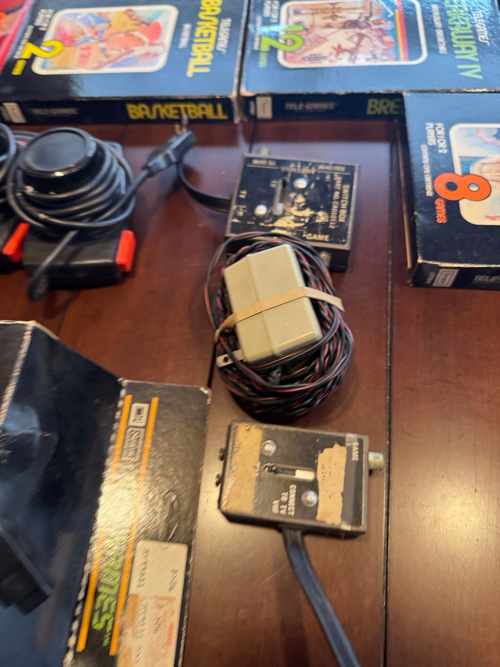 The Barch Atari 2600 collection laid out: console, joystick and paddle controllers, and the boxed cartridges named in the description