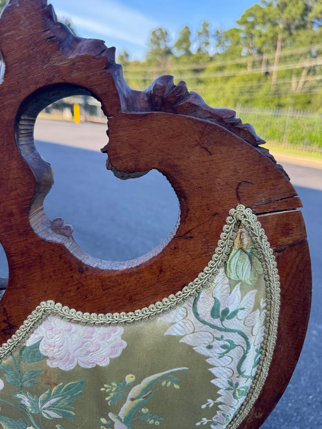 Condition detail: the back of the crest rail, with a split running through the show wood beside the piercing