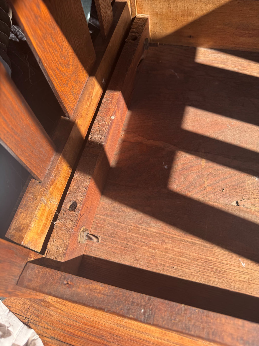 Bottom shelf interior view showing wood grain, support structure, and construction method