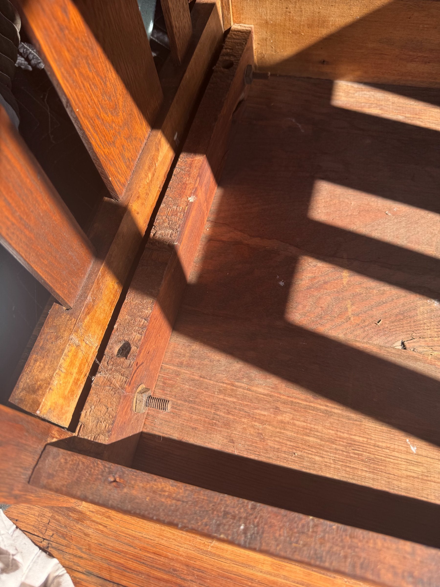 Bottom shelf interior view showing wood grain, support structure, and construction method