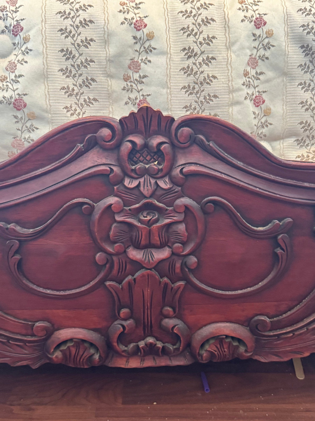Carved centre panel of the footboard with scrolls and flowers