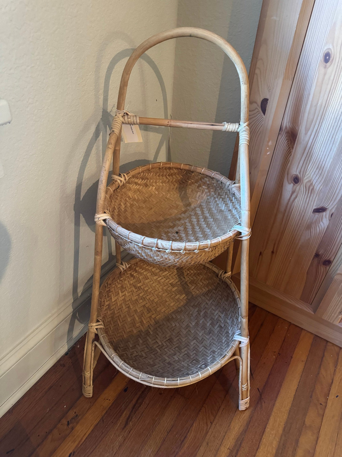 Two-tier rattan stand with white accents