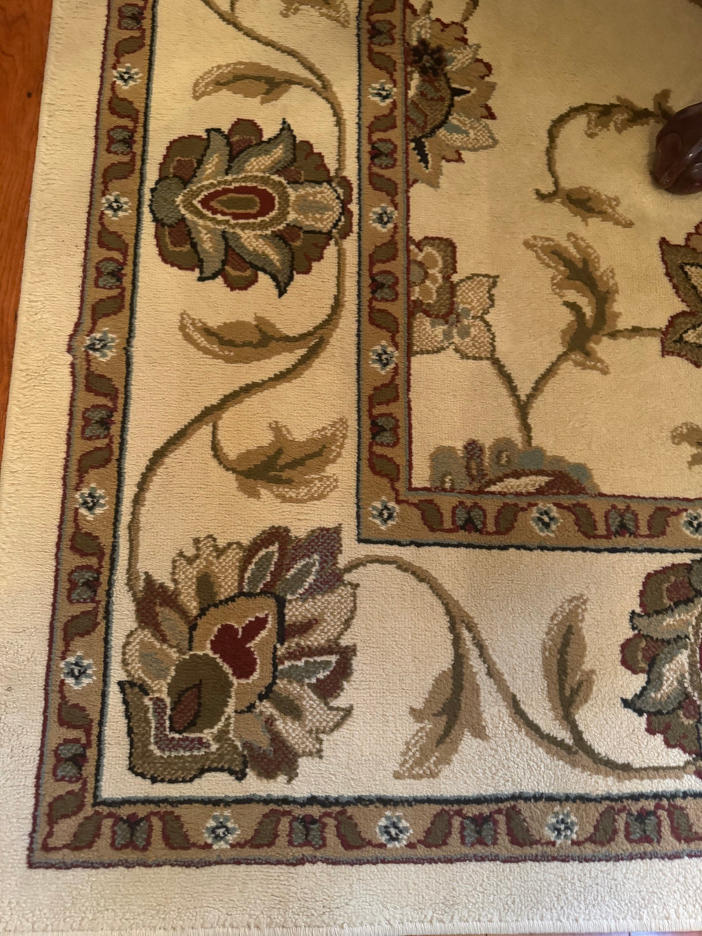 Close-up corner of the rug showing floral border pattern