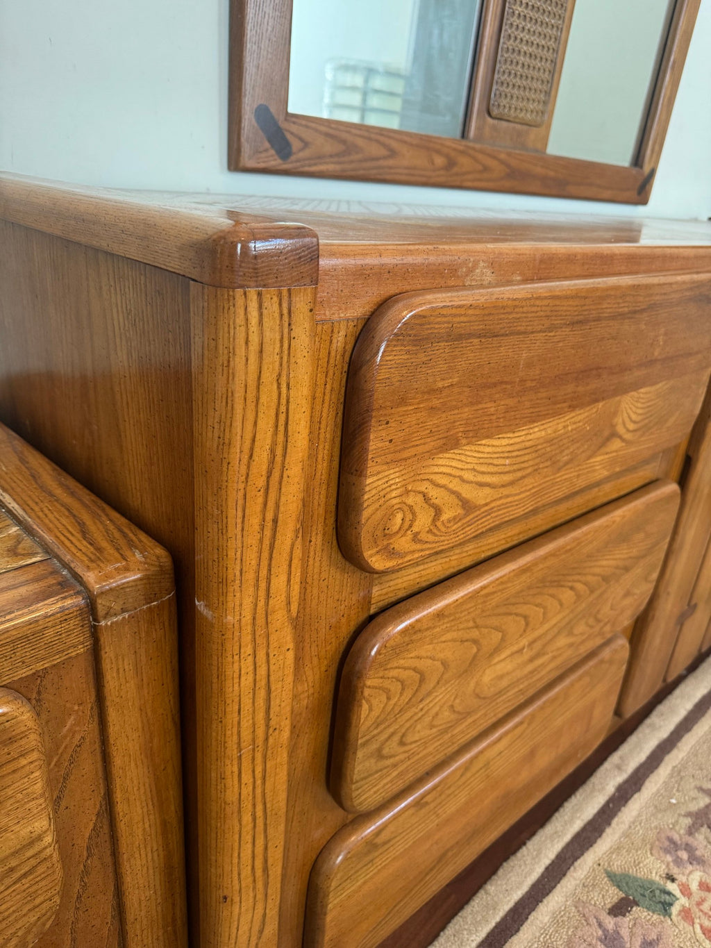 Corner of the dresser showing rounded drawer fronts and oak grain