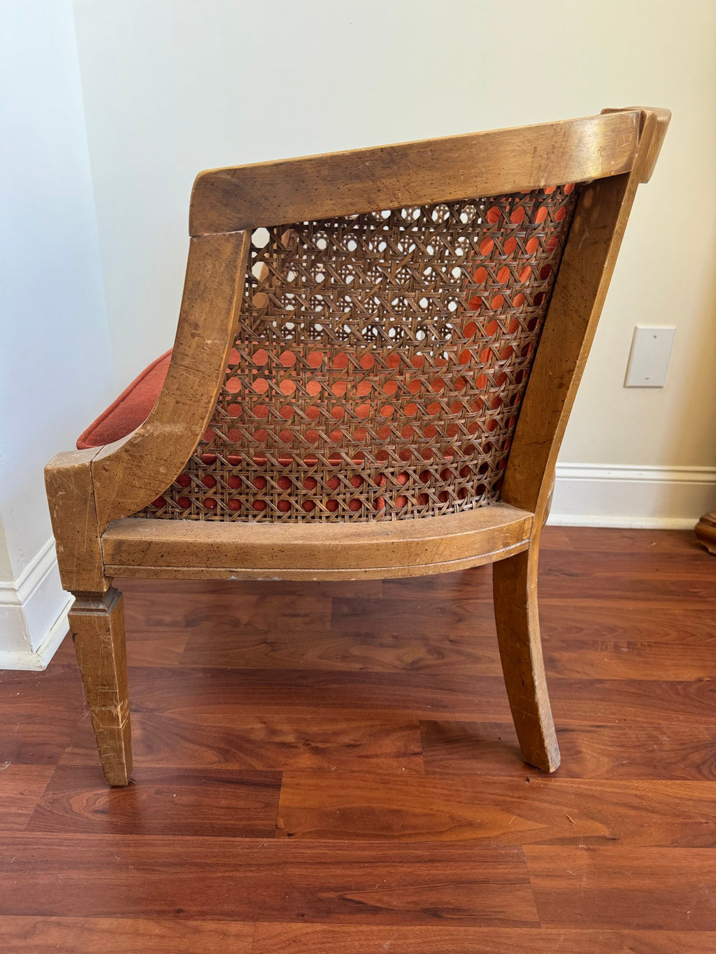 Barrel chair in profile showing the cane side and tapered legs