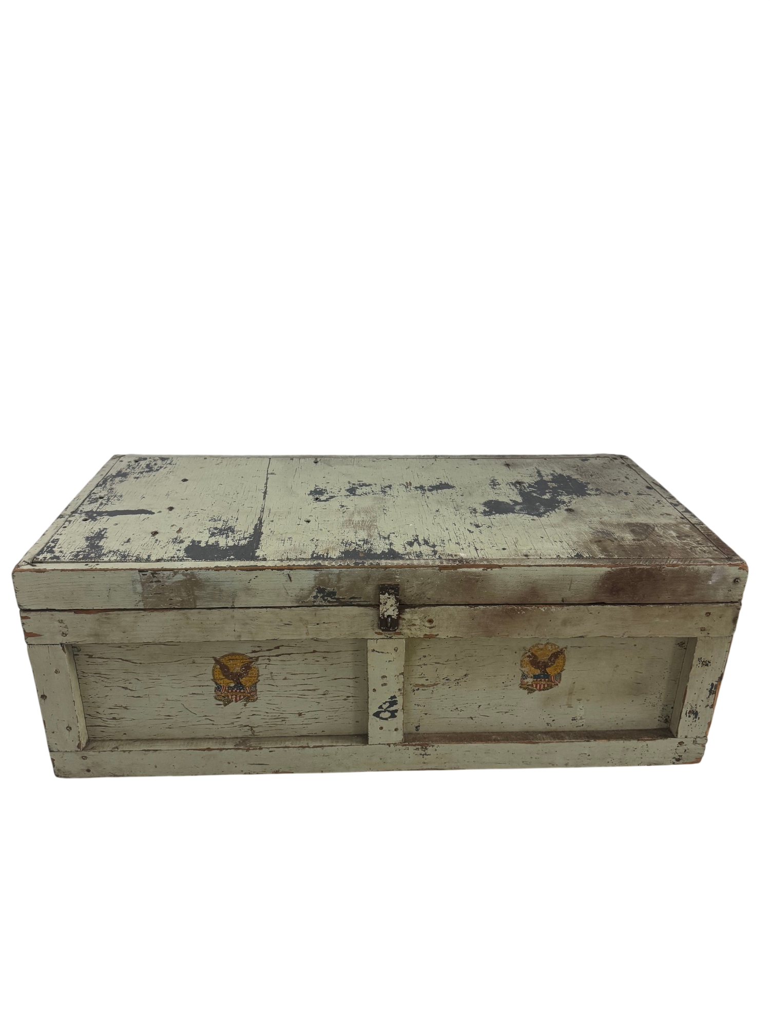Cream-painted wooden trunk with two gold eagle decals, viewed from front angle, showing distressed finish and metal hardware