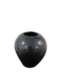 Black polished ceramic pottery vase with rounded bulbous form and small opening at top, displayed against white background