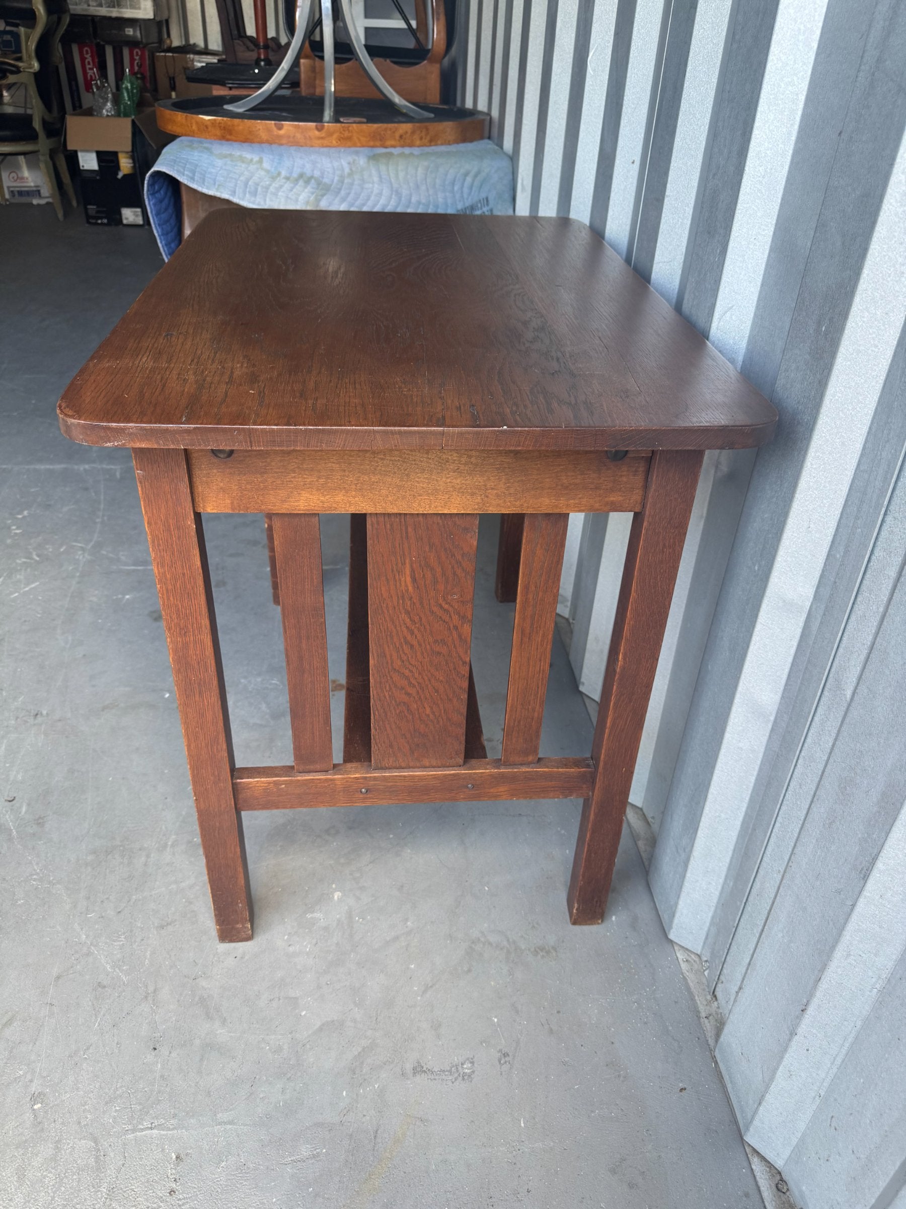 Dark stained oak table from front angle, rectangular top with shelf beneath, four square legs